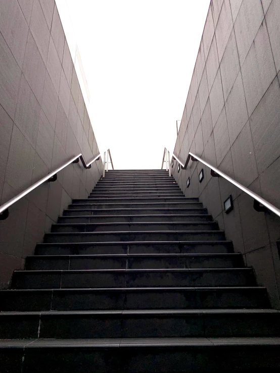 black and white pograph of stairs at the bottom of a stairwell