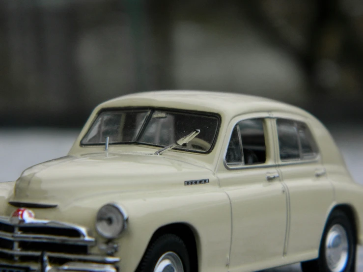 a small model of a white classic car