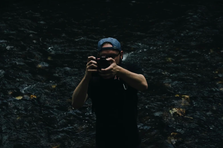 a man holding up a camera to take a po