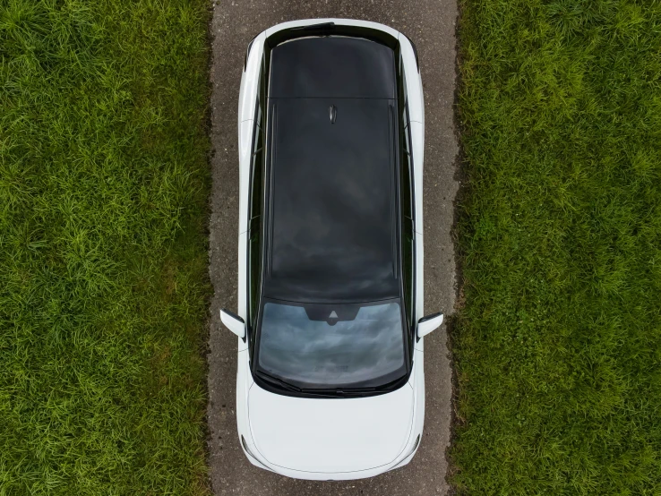 an overhead view of the roof and top of a car on a dirt path