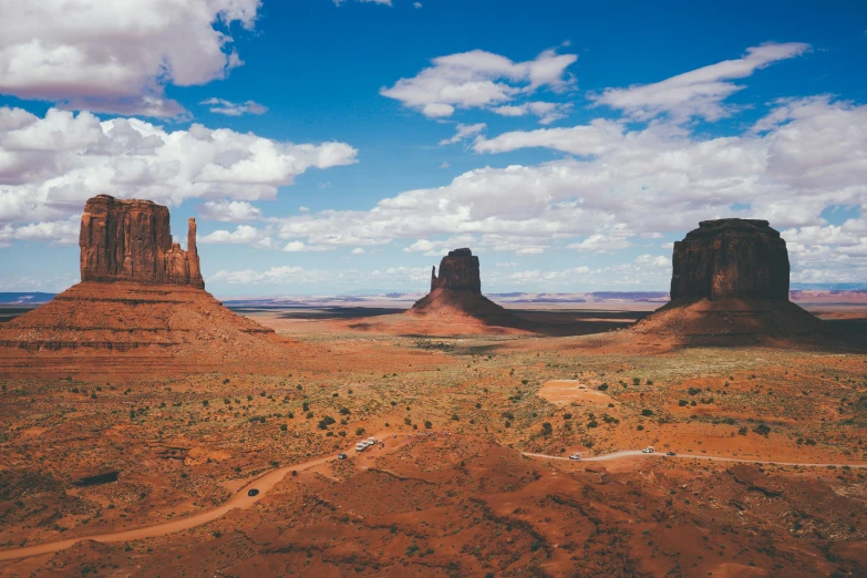 a desert landscape with rock formations in the distance