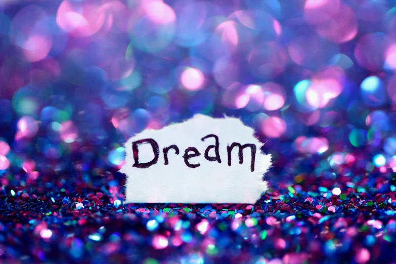 the word dream is written on top of the piece of paper