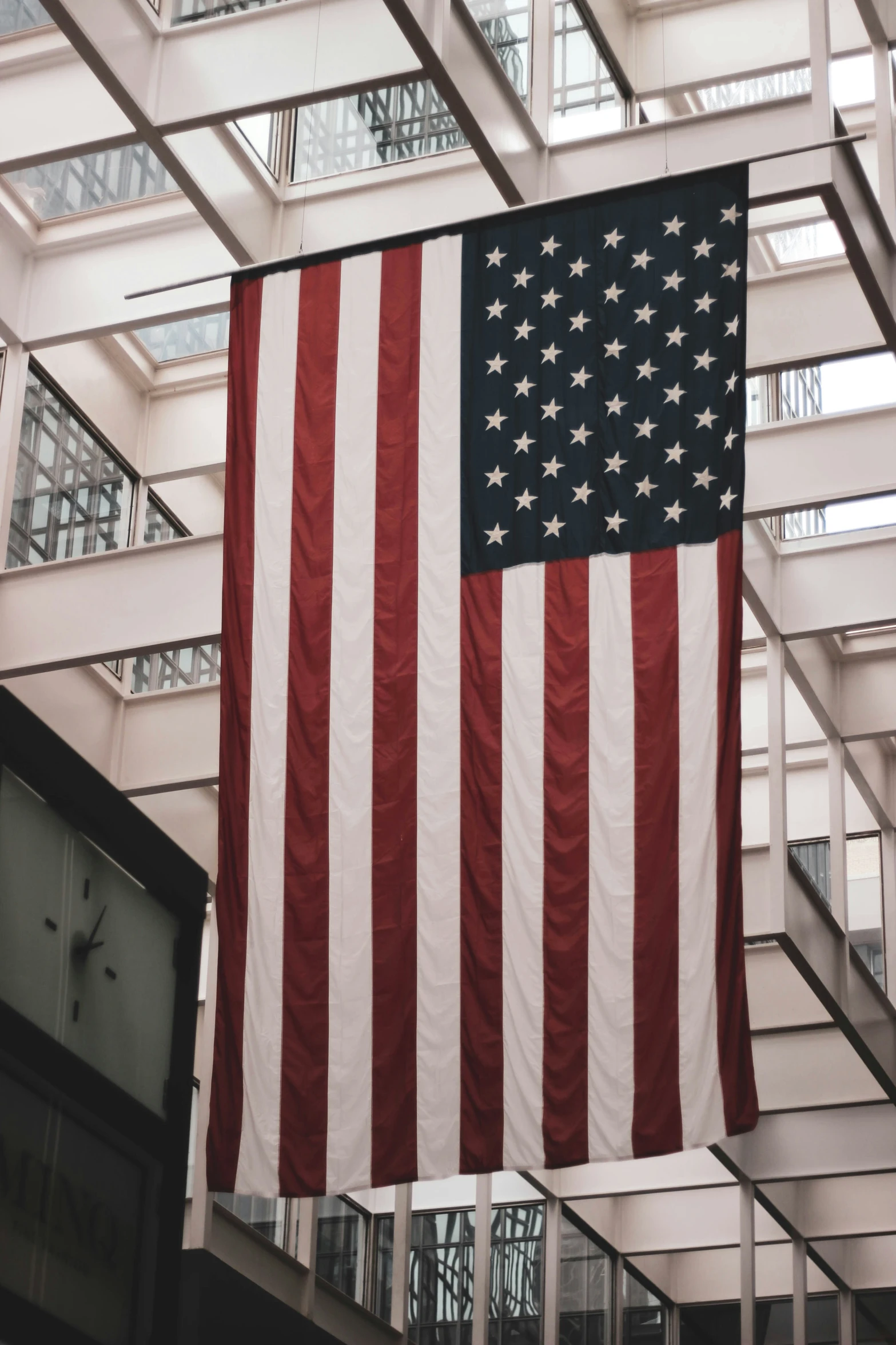 a large american flag hanging in the ceiling