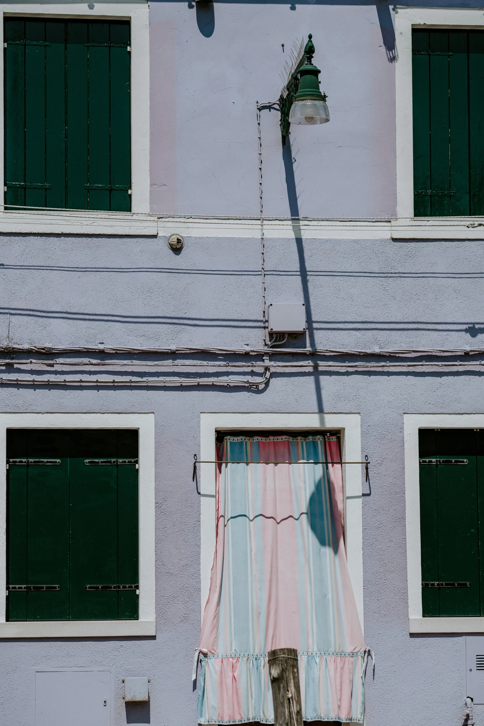 the curtain in front of the windows is drawn upward