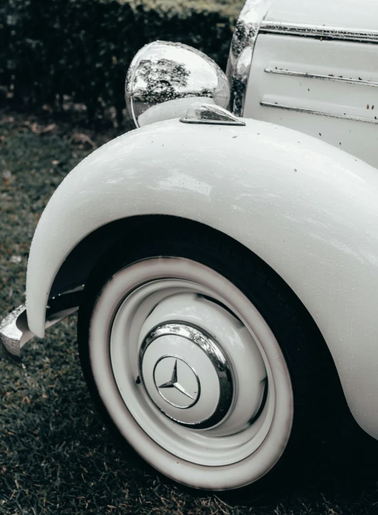 the front end of an old - fashioned white automobile