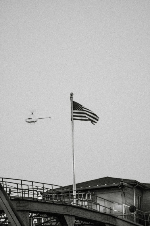 an airplane flying in the air above an american flag