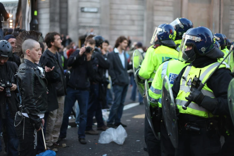 a group of policemen standing in a city street with police standing behind them