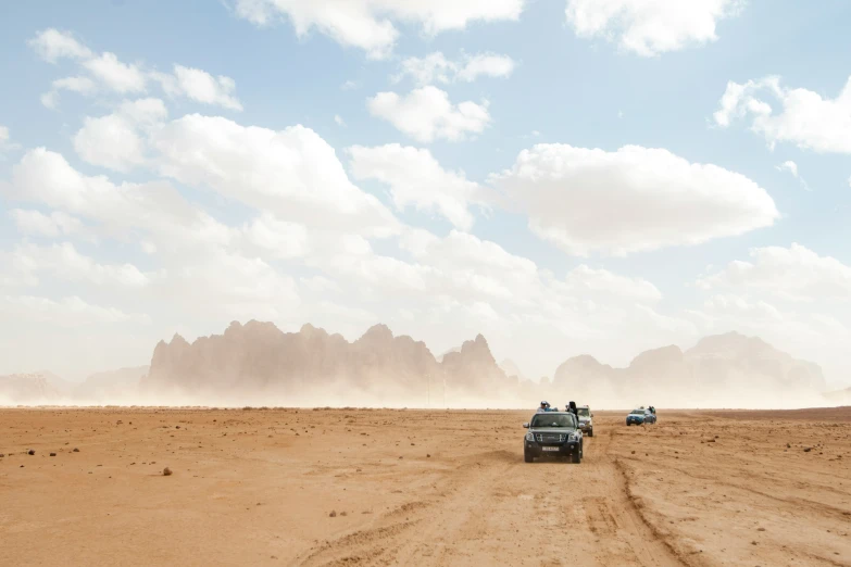 some very nice cars in the middle of a desert