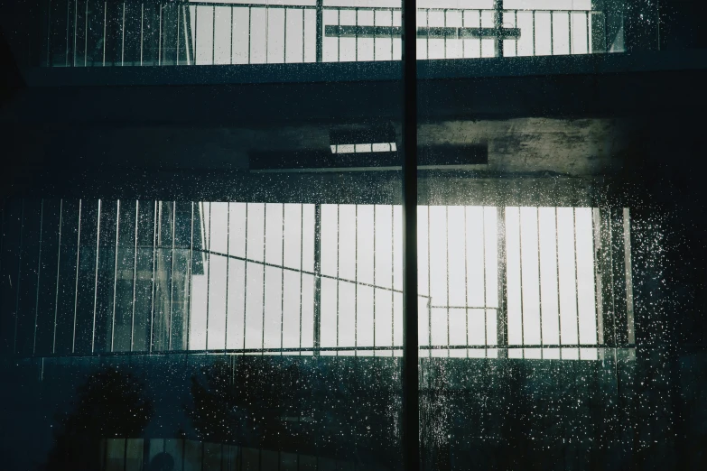 a dark building with lots of windows and bars