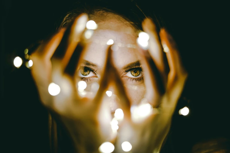 the person is showing her eyes behind lights