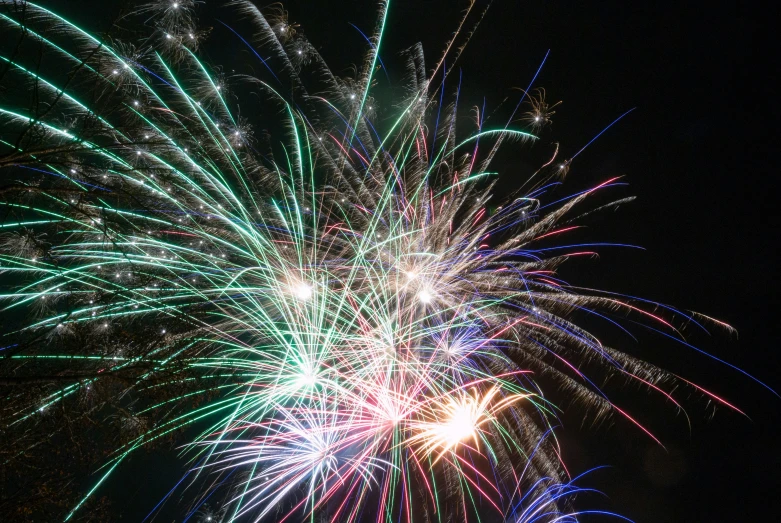 a colorful fireworks with green, red and blue lights