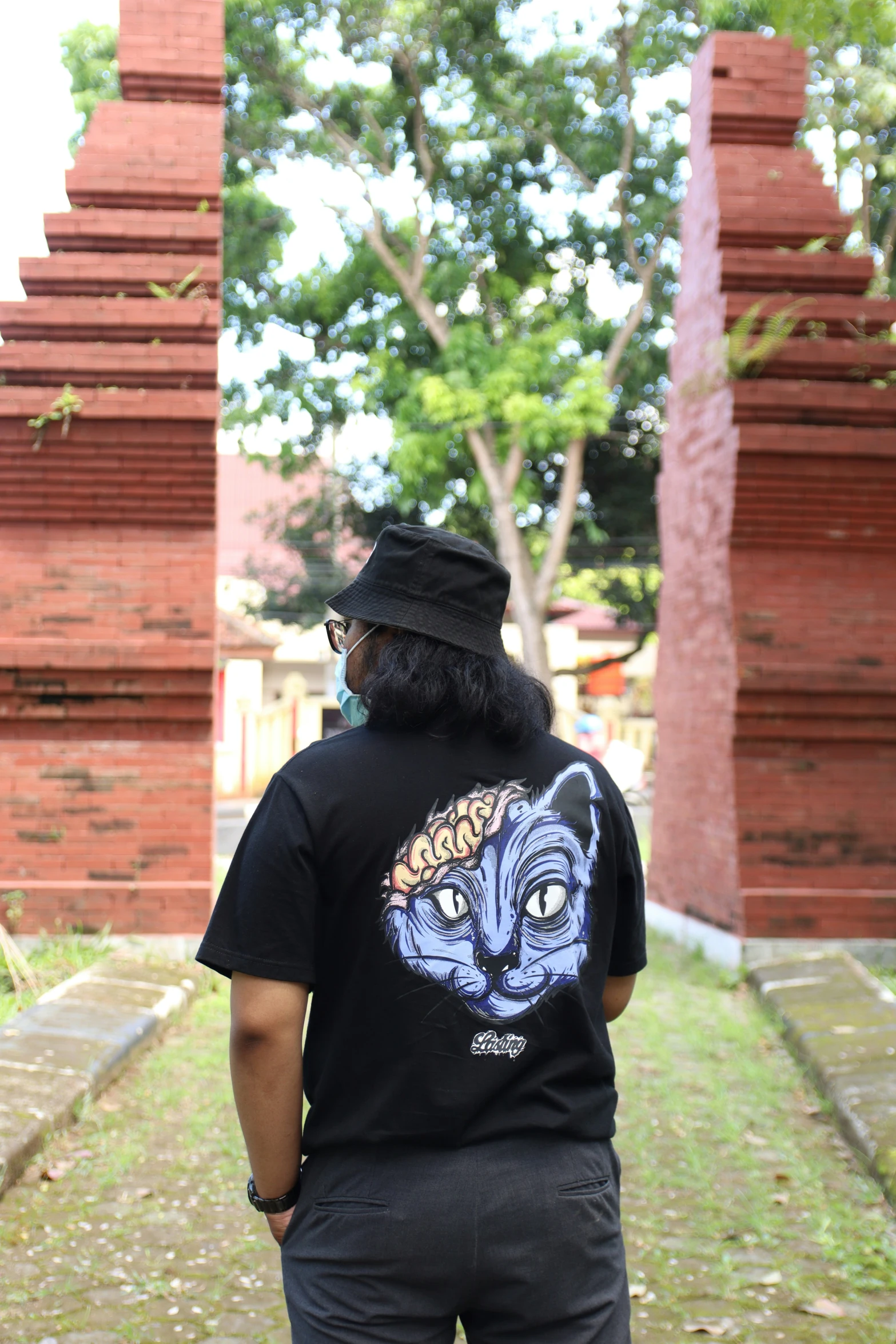 a man wearing a t - shirt that has a tiger head on it