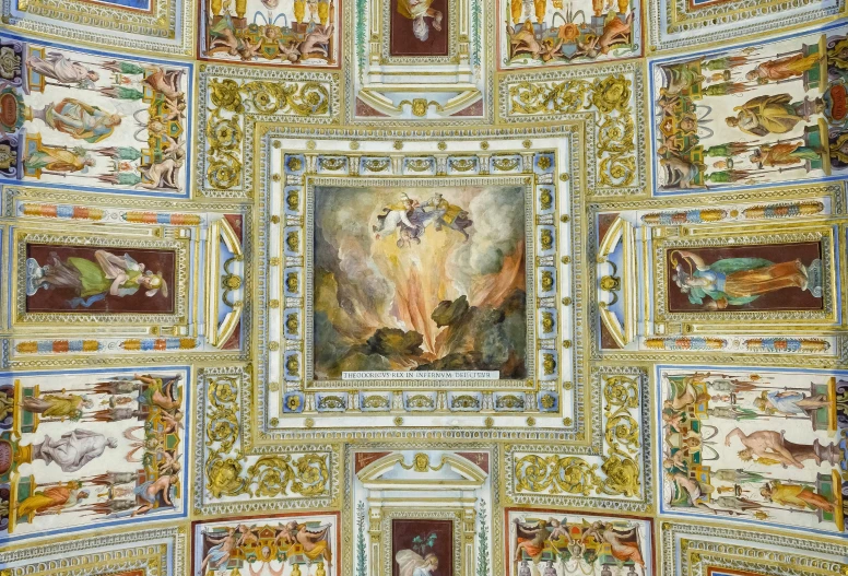 a room with paintings on the ceiling is decorated with gold