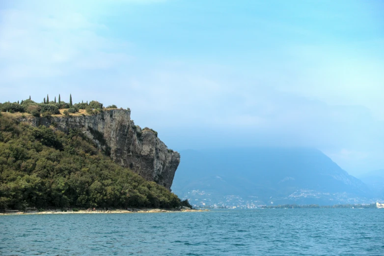 the view of a rock island with some trees on it