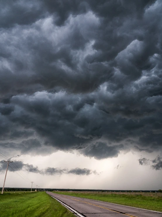 stormy sky above a country road near the outskirts