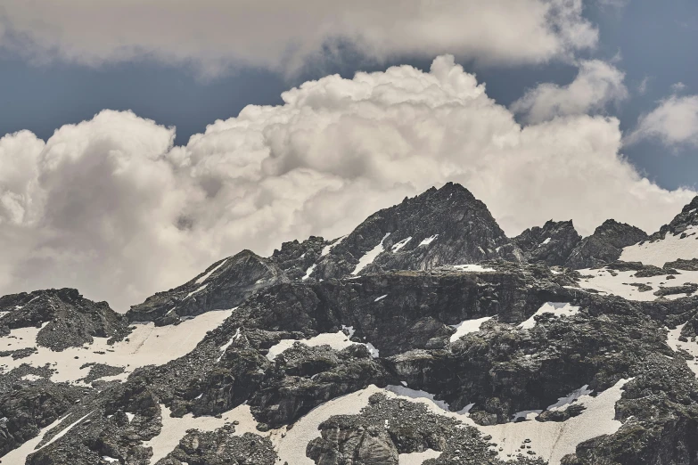 the top of a mountain with white snow