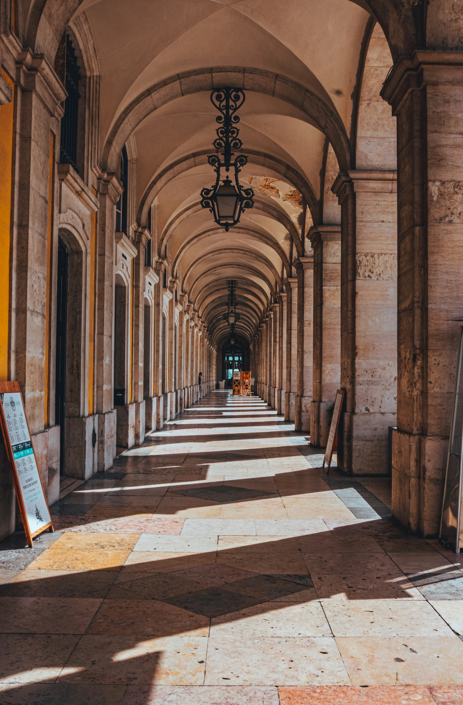 a large hallway with arches and a sidewalk