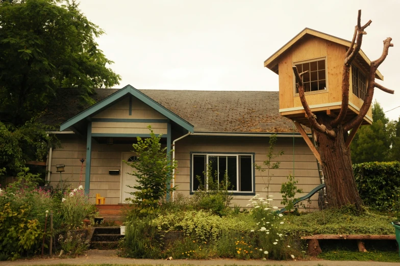 a tree house sits high up on a house's roof