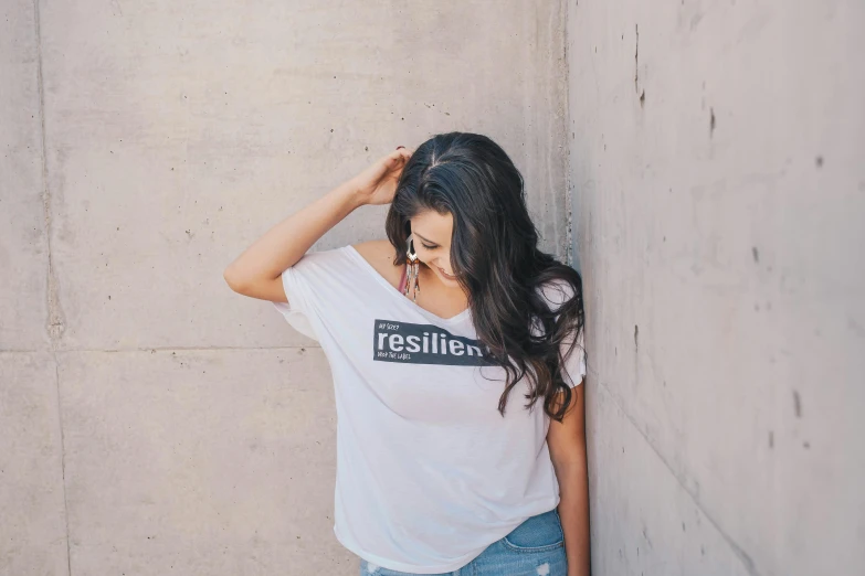 a woman wearing an liesley shirt and denim shorts