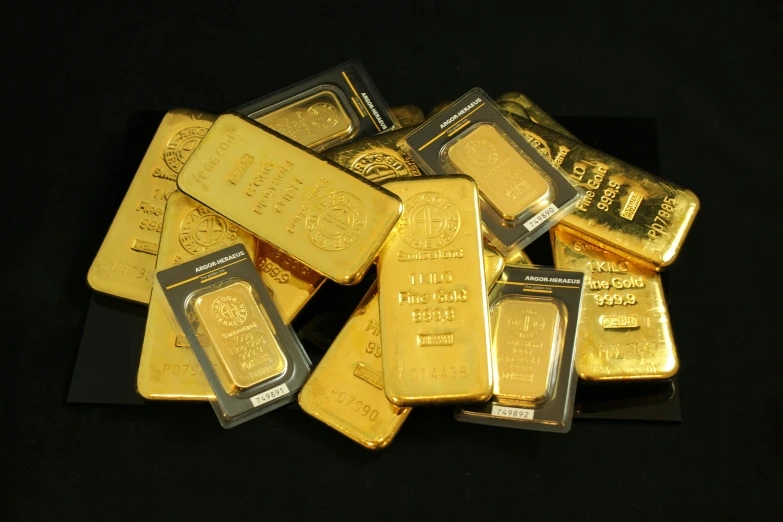 a pile of gold bars that are sitting on a table