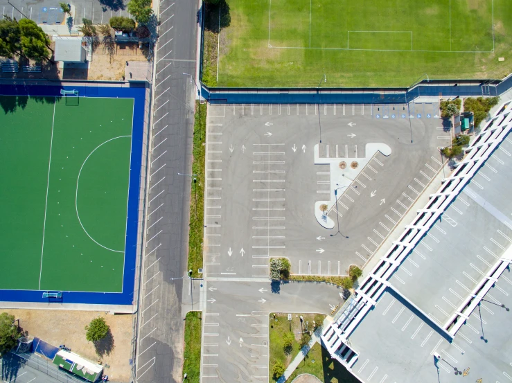 an overhead view of two basketball courts and cars