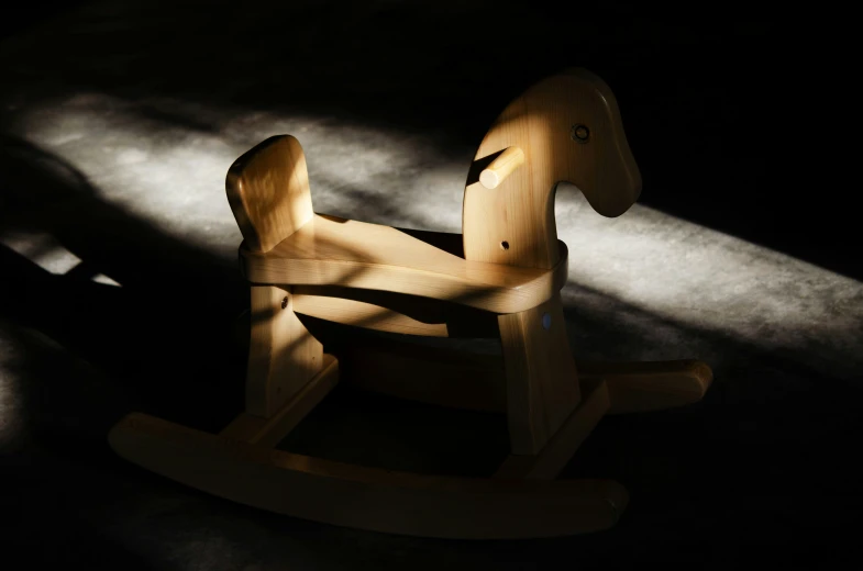 a rocking horse made from natural wood that has been crafted