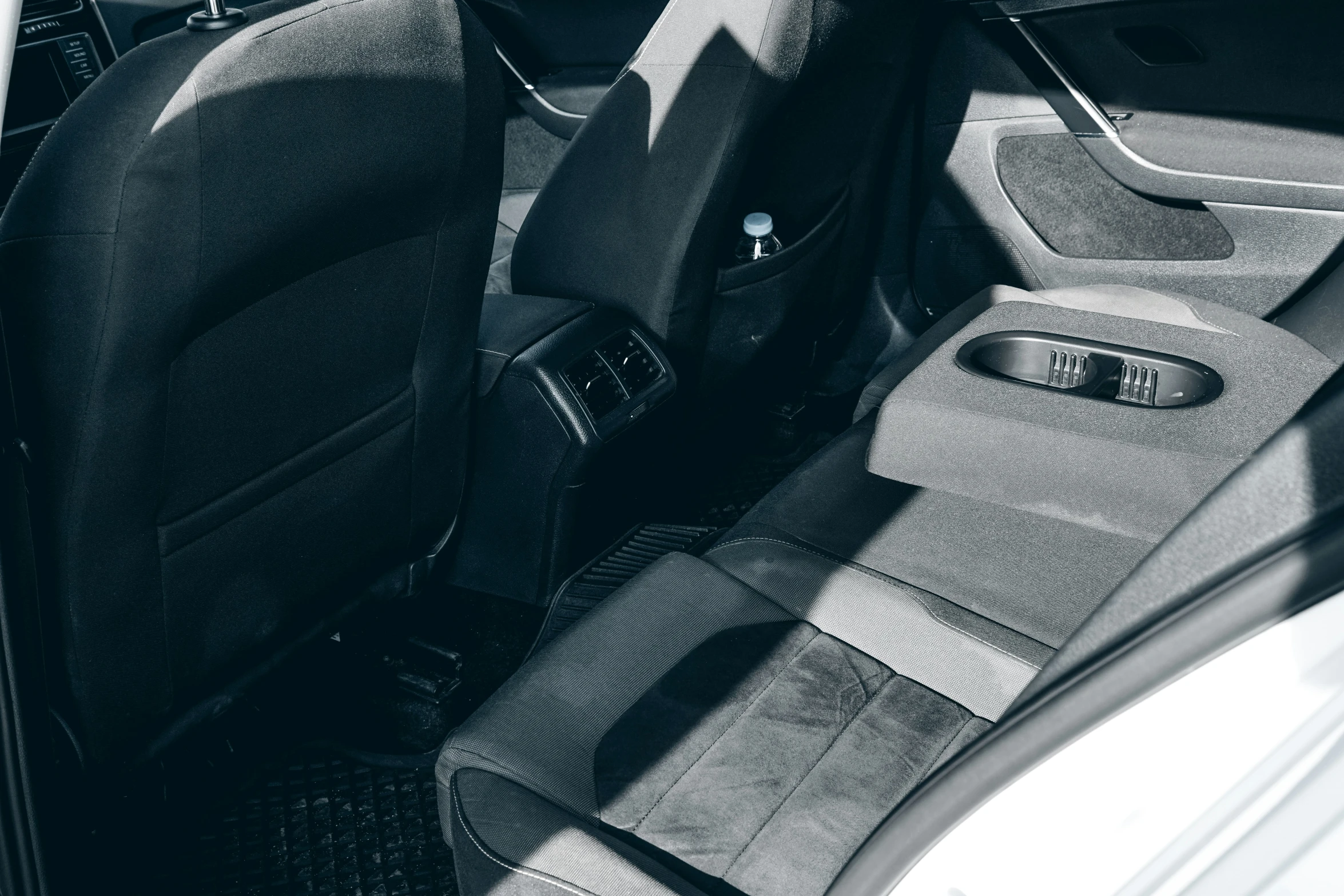 black and white image of a back seat inside of a car