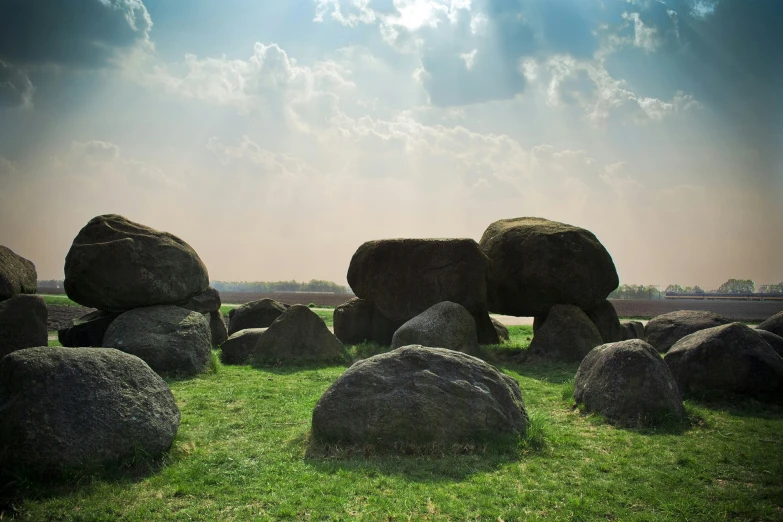 a field full of huge rocks sitting in the grass