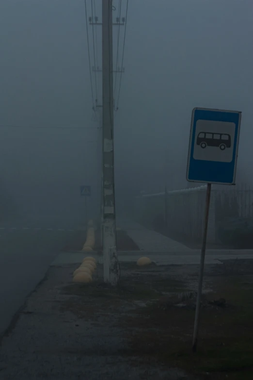 a sign on the street next to a traffic light and road