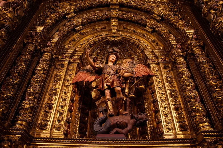 a statue on top of a cathedral wall