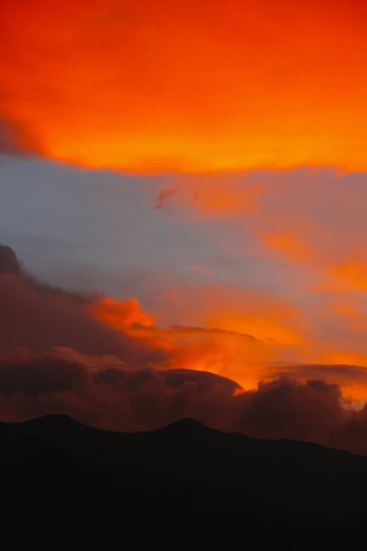 an airplane flying through a colorful sky in the evening