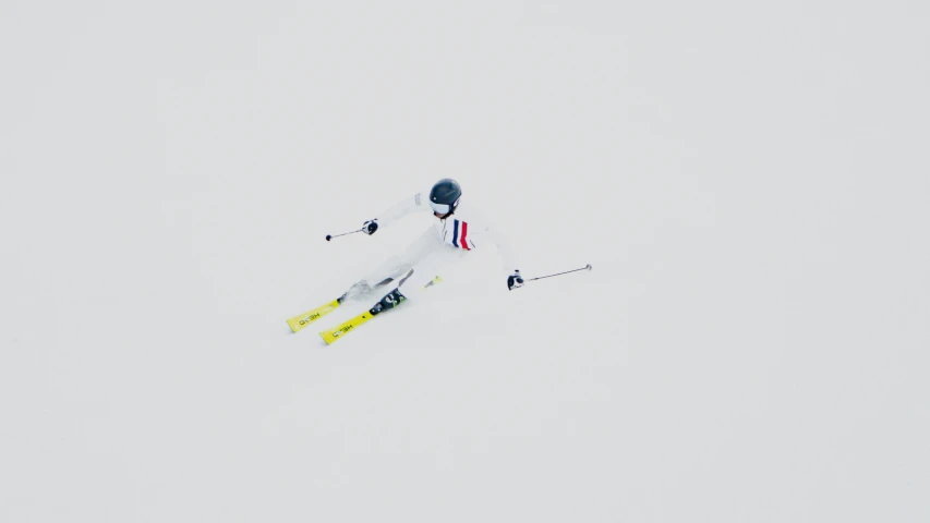 a person on skis going downhill on a snowy day