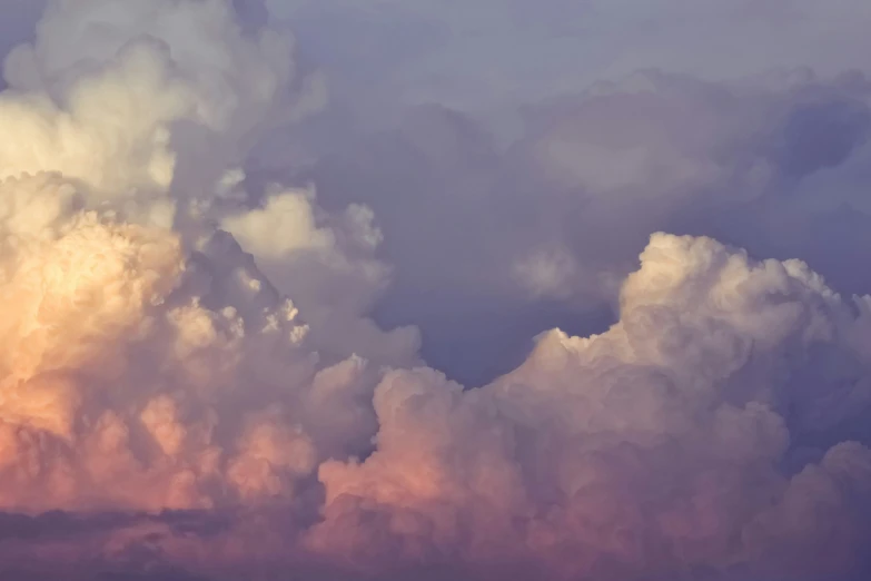 an airplane flying through a cloudy sky