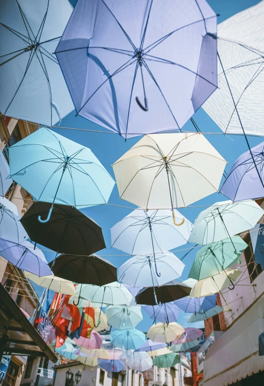 a bunch of umbrellas that are up high in the air
