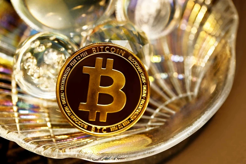 a close up of a bitcoin on a clear plate