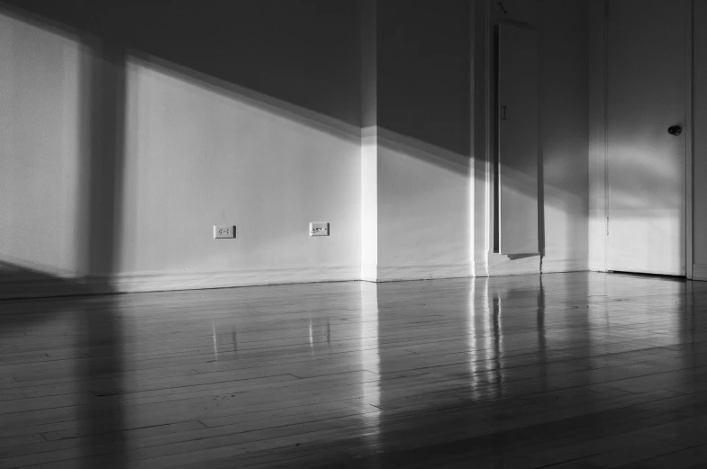 a large open room with light coming in through the door