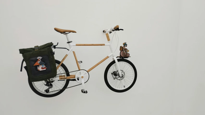 a white bike with a backpack sitting on top of it