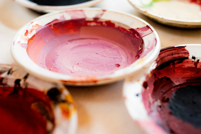 plates with paint sitting on the table top