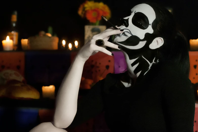 a woman in skeleton makeup talking on her phone