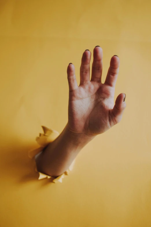 a hand is reaching up toward an object