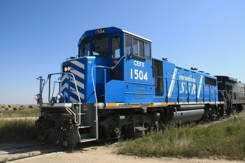 a train is driving through an open field