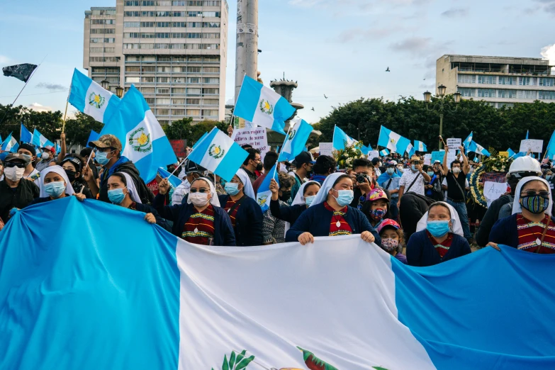 a group of people in masks and flags