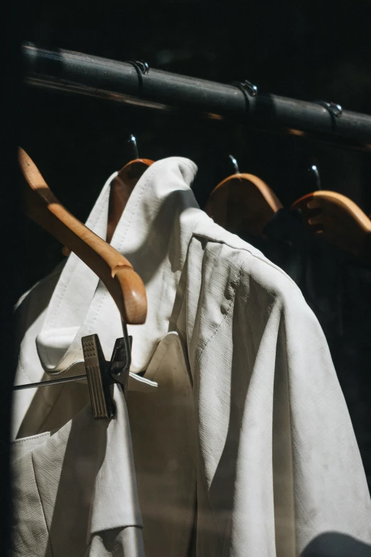 three wooden paddles are hanging from the clothes rail