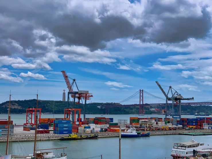 the boat docks with some boats in it and cranes