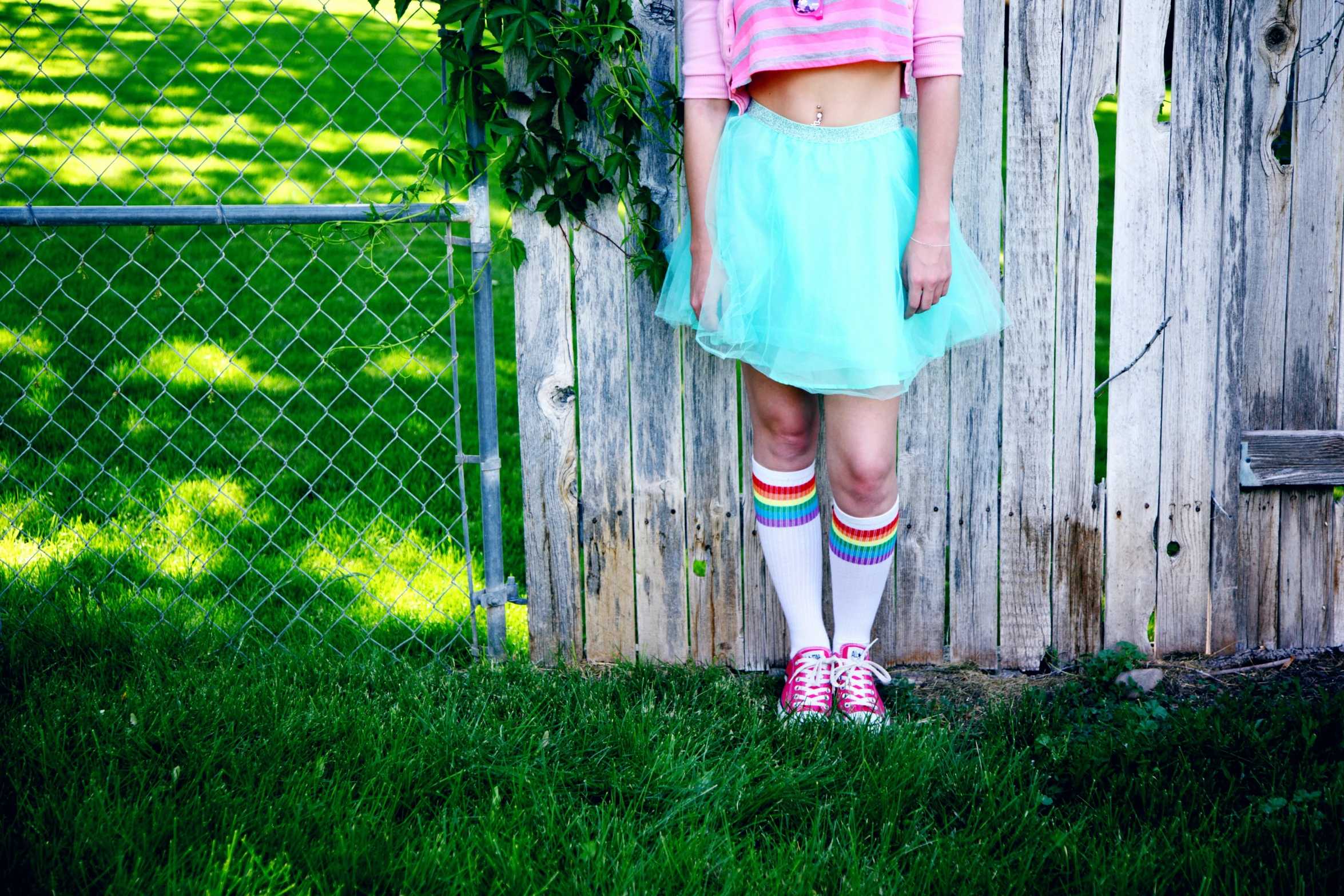 a  in a short skirt with a colorful striped sweater on