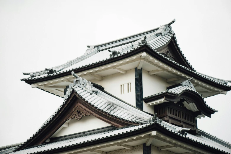 a tall building with three roof tops on top of it