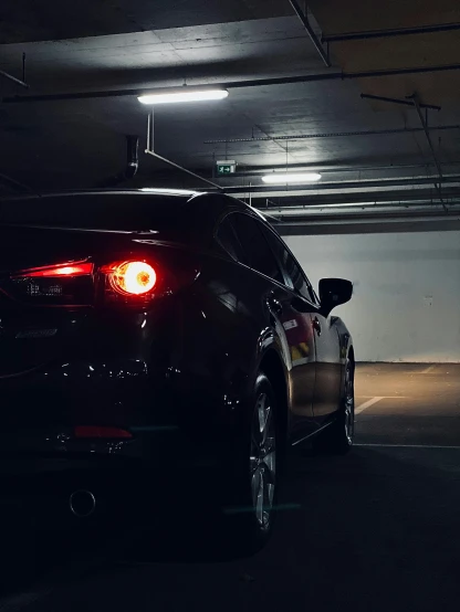 a car is parked under a darkened parking garage