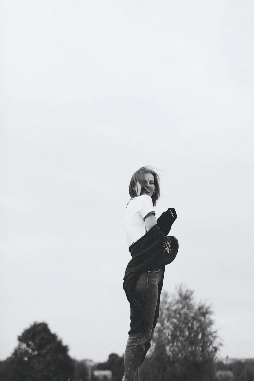 a person jumping up and holding a skateboard