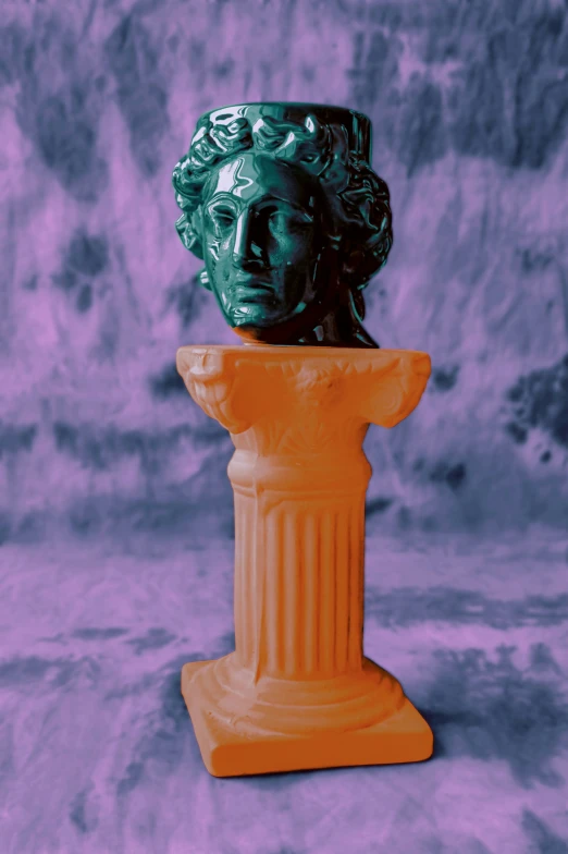 an orange vase sitting on top of a pedestal