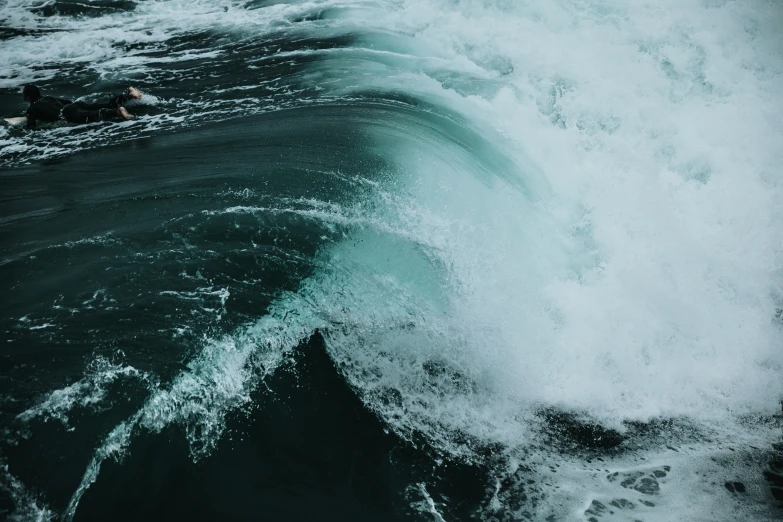 two people are surfing through the waves in the ocean